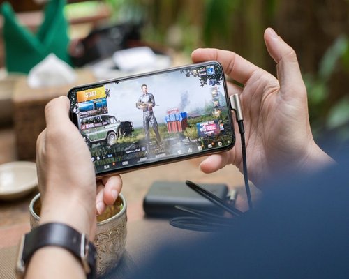 Angled smartphone showing the fictional Coral Base Explorer mobile game
